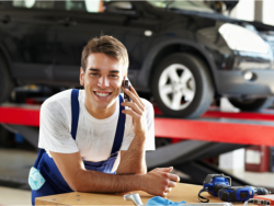 Male mechanic talking someone to the phone